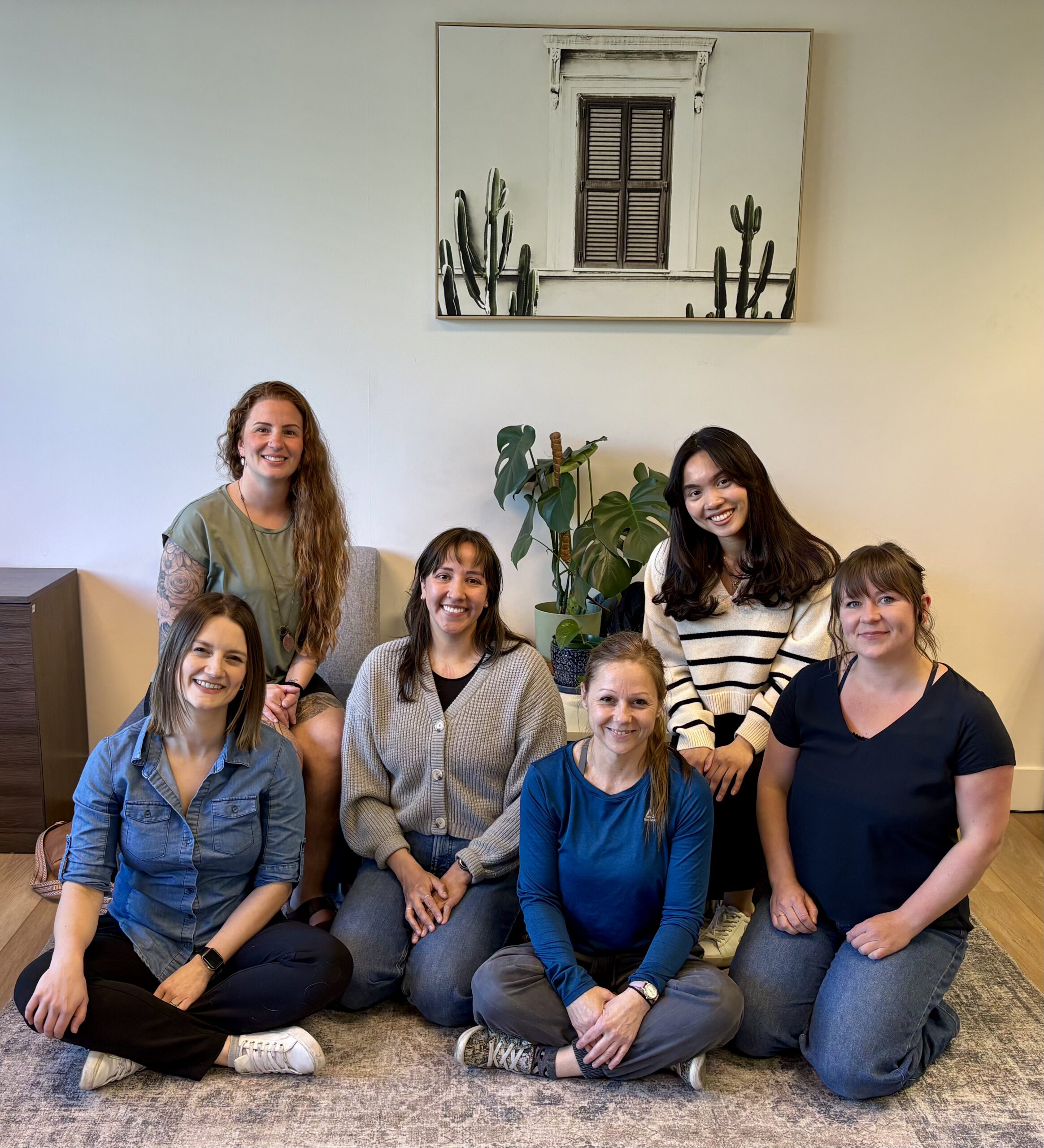 Team photo of Wordplay Therapy employees smiling together in a welcoming office environment.